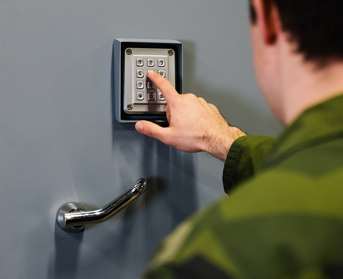 Operator entering a code into a secure keypad